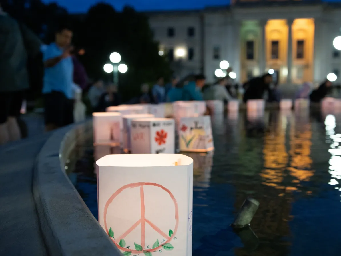 lantern floating on water with peace symbol